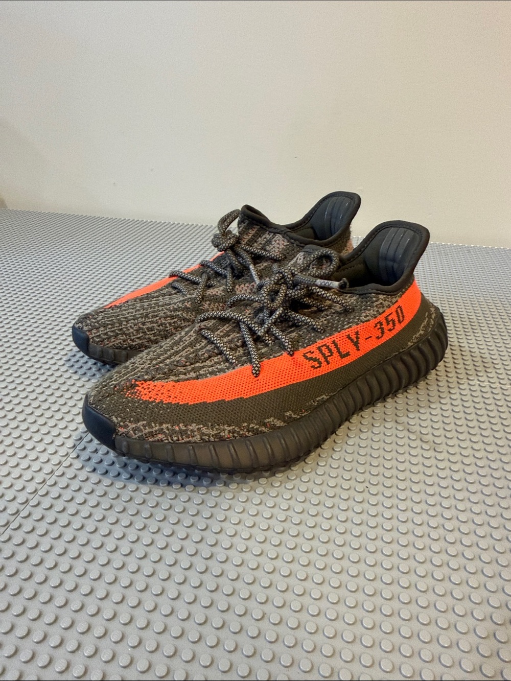Yeezy men’s Black Knit Sneakers with Bright Orange Stripe